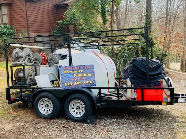 Professional pressure washing trailer with commercial equipment, soft wash system, and hose reels from Absolutely Clean Power Washing